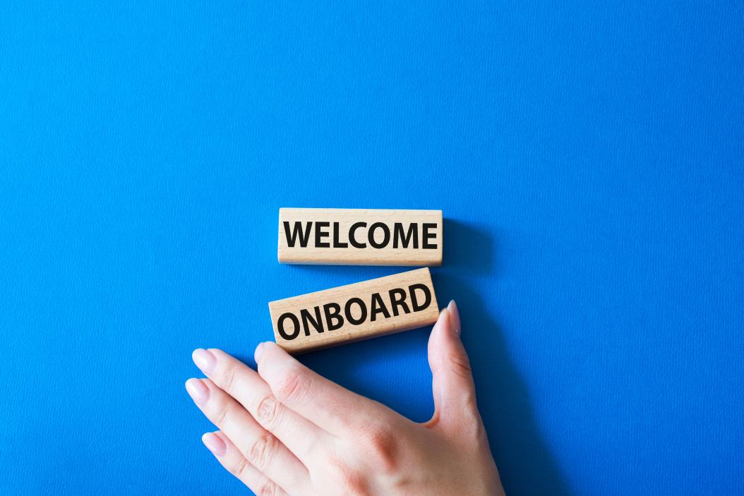 Zwei Holzbausteine, die untereinander gereiht sind und sagen: "Welcome onboard" 
